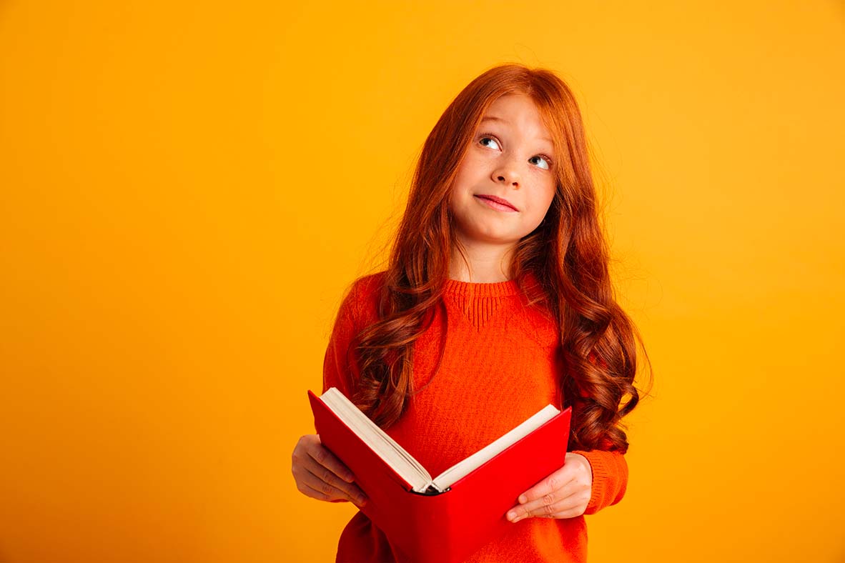 Une jeune lectrice tient un livre sur un fond orangé.